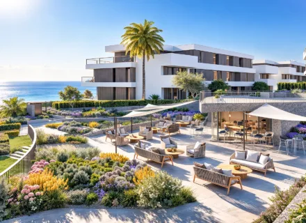 Modern seaside apartments with landscaped gardens, lounge terrace and palm trees overlooking the ocean.