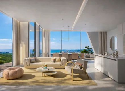Bright open-plan living and kitchen area with modern design, floor-to-ceiling windows and panoramic sea views.