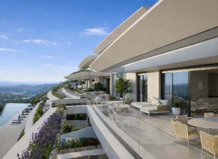 Azurean Marbella luxury apartment terrace with outdoor seating, glass balustrades, panoramic views and modern architecture