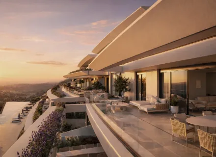 Azurean Marbella sunset apartment terrace with outdoor seating, warm evening light, panoramic views and luxury architecture