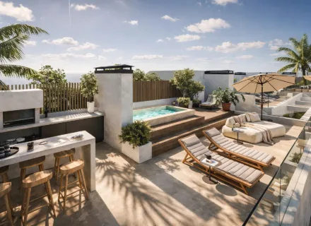 Luxury rooftop terrace with private plunge pool, sun loungers, outdoor kitchen and sea views under sunny Mediterranean sky.