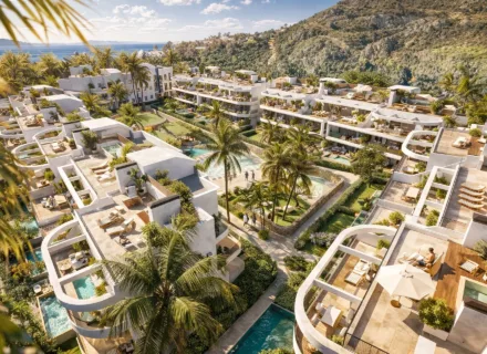 Aerial view of luxury apartments with rooftop terraces, private pools, palm trees and Mediterranean sea backdrop.