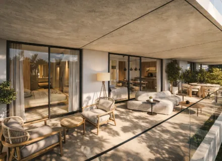 Modern apartment terrace with lounge seating, dining area and large glass doors connecting to bedroom and kitchen.