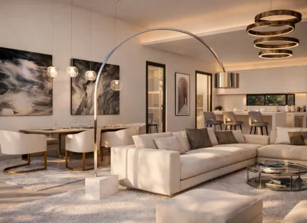 Elegant open-plan living and dining area with designer lighting, neutral furnishings, modern kitchen and warm ambient light in luxury villa