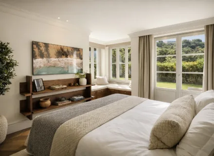 Bright bedroom at Villa Liora in Marbella with large windows, garden views, bespoke shelving and elegant neutral décor