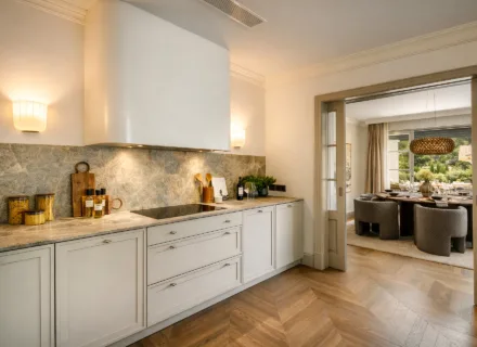 Elegant kitchen at Villa Liora in Marbella with marble countertops, bespoke cabinetry and seamless flow to dining area