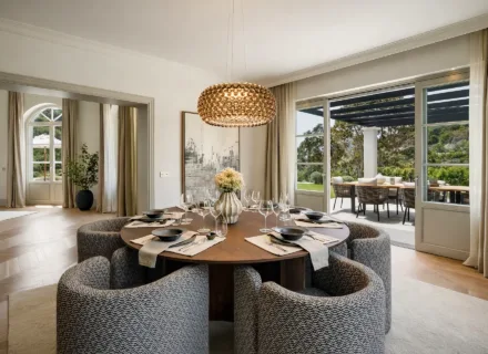 Elegant dining area at Villa Liora in Marbella with designer lighting, round table setting and direct access to outdoor terrace