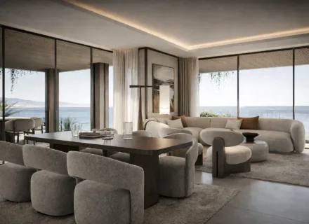 Elegant dining and living area at Sierra Blanca by the Sea with panoramic glazing and open sea views