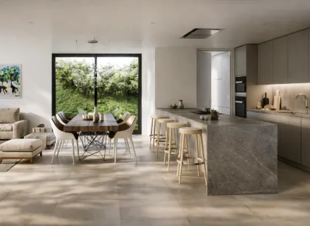 Stylish open-plan interior at Ayana Estepona featuring modern kitchen, dining area and natural light with garden views.